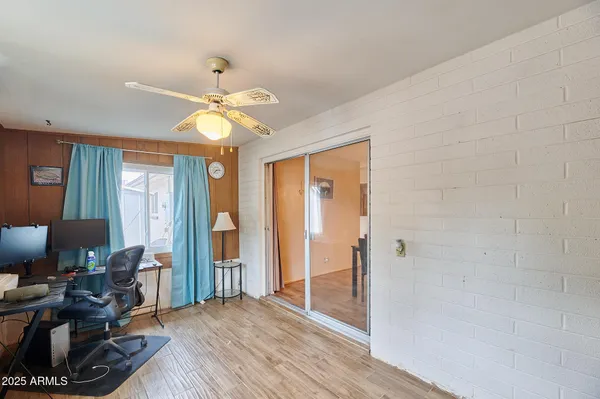 a view of a livingroom with a window and wooden floor