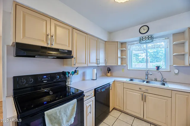 a kitchen with a sink stove and cabinets