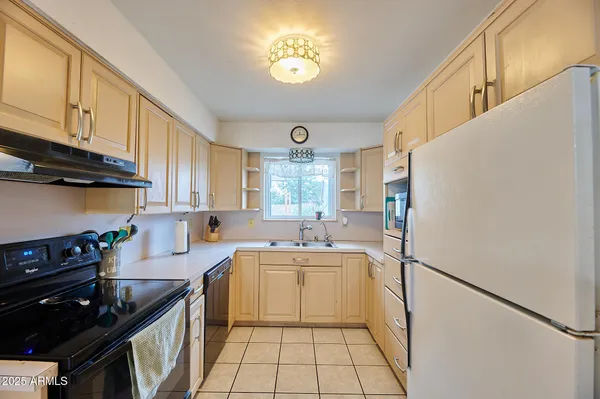a kitchen with a sink appliances and cabinets