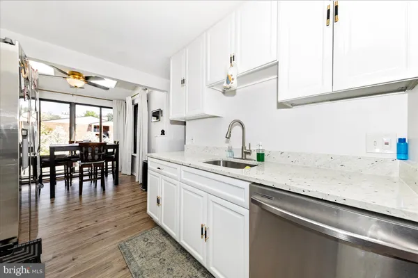 a kitchen with stainless steel appliances granite countertop a sink and cabinets