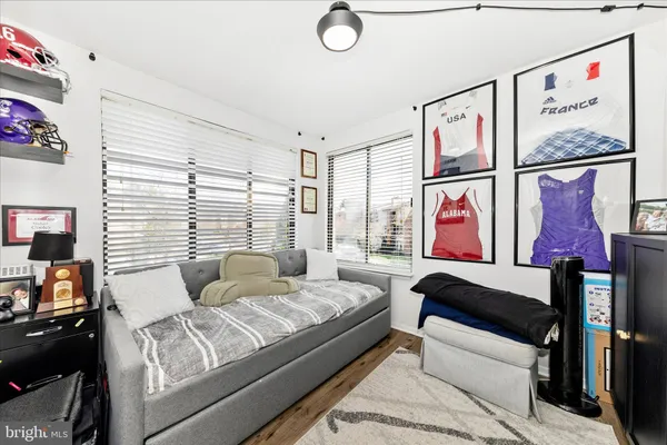 a bedroom with furniture and a window