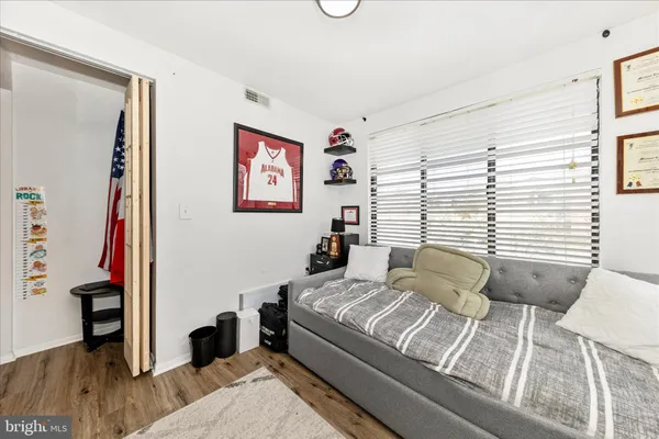 a large bedroom with a bed and a window