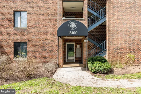 a view of a brick house with large windows