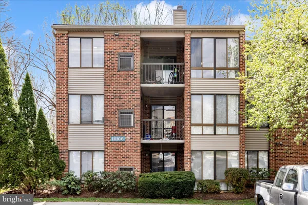 a front view of a residential apartment building with a yard