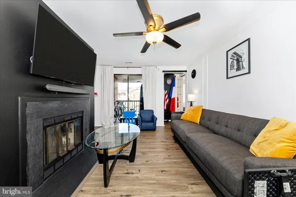 a living room with furniture a flat screen tv and a fireplace