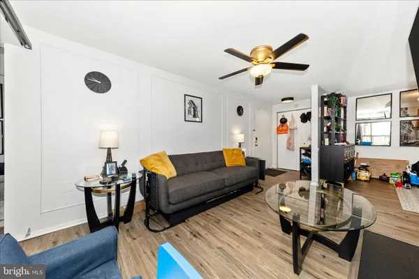 a living room with furniture and wooden floor