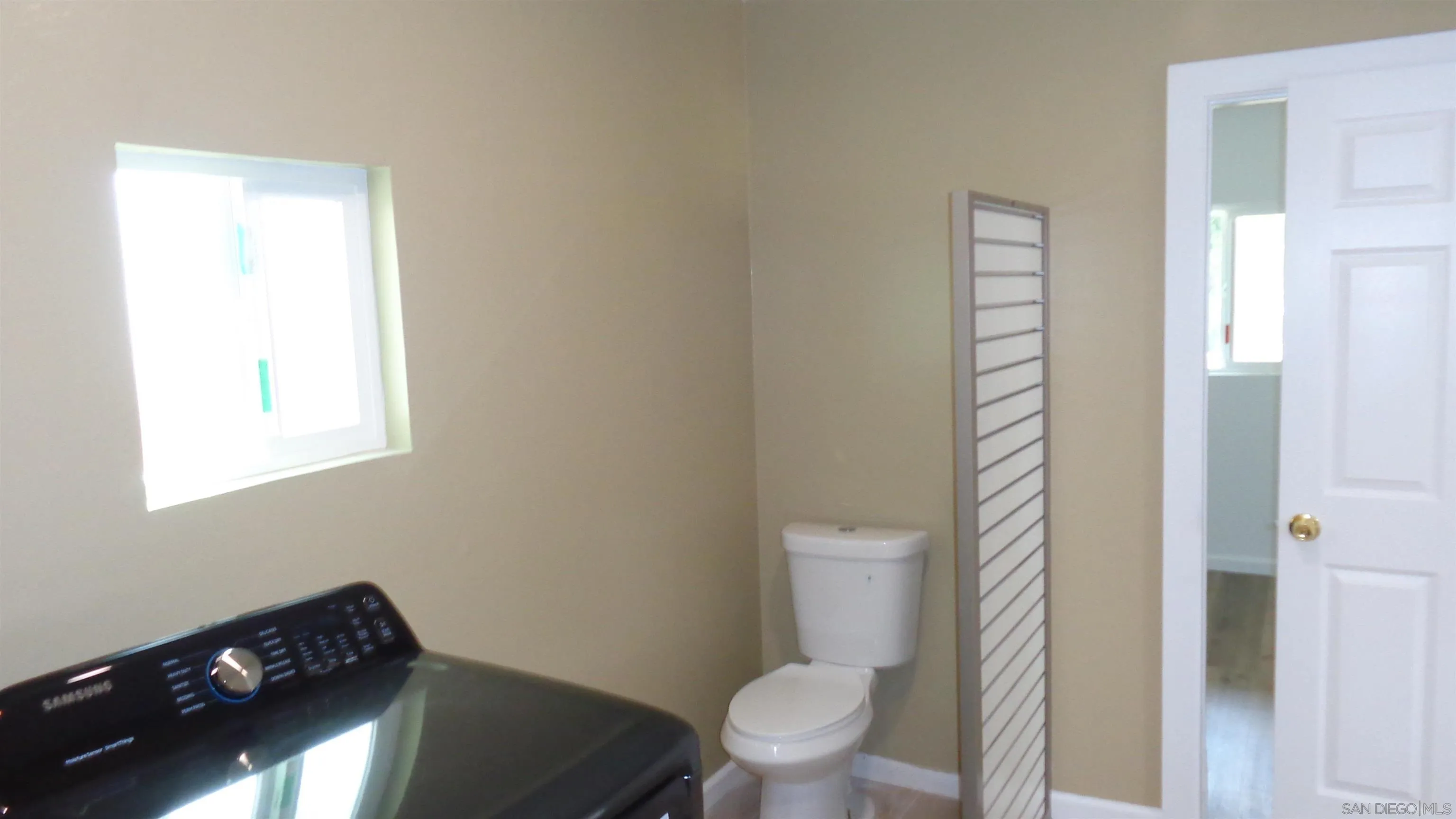29660 Wilkes Road Valley Center, CA 92082 - Photo 6 of 16 a bathroom with a toilet a sink and a window