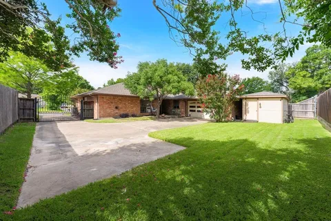 a front view of house with yard and tree