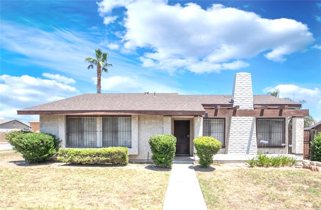789 North Chestnut Avenue Rialto, CA 92376 - Photo 1 of 1 a front view of a house with a yard