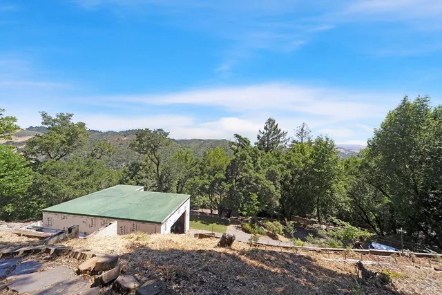 a backyard of a house with table and chairs