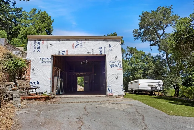 a front view of a building with trees