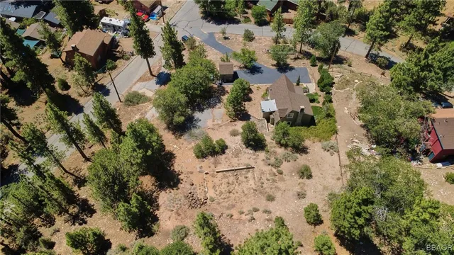 an aerial view of a house with yard and outdoor seating