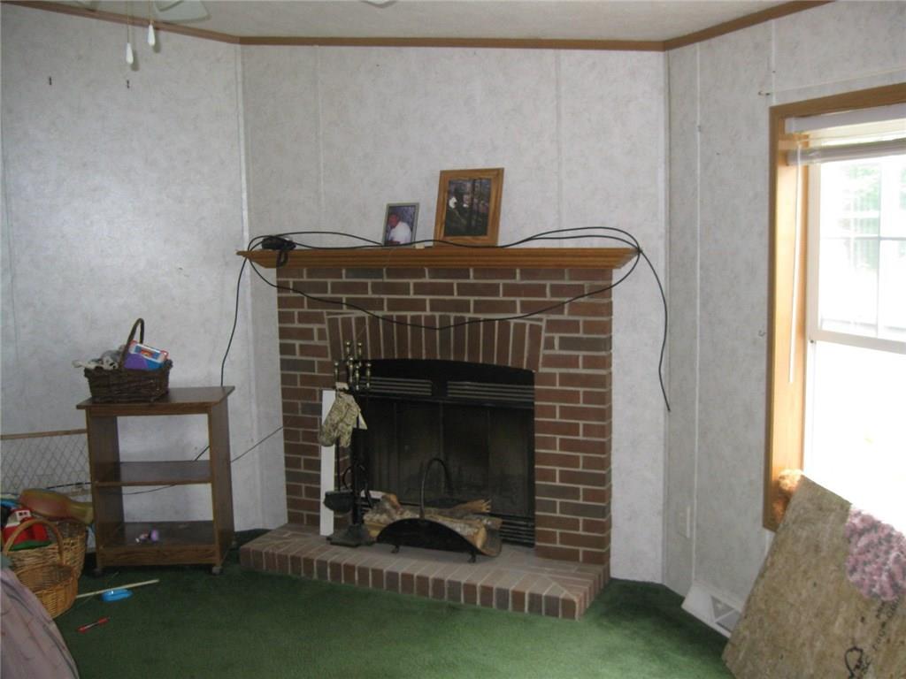 474 Plummer Road Palermo, ME 04354 - Photo 5 of 16 Wood burning fireplace in family room.