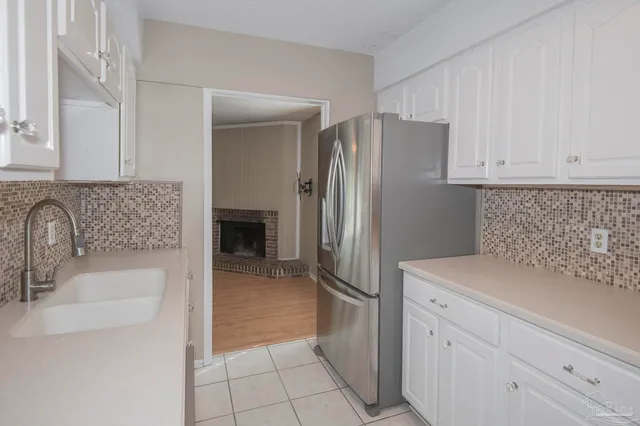 a kitchen with a sink and a refrigerator