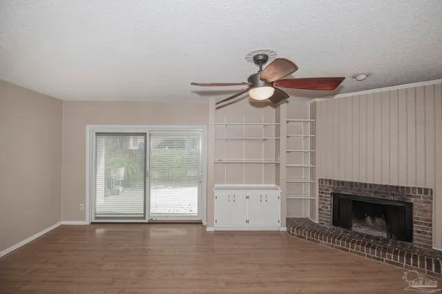 a view of a livingroom with a fireplace and cabinet