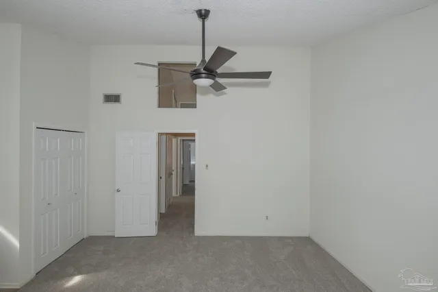 a view of a big room with closet and windows