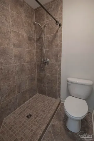 a white toilet sitting next to a bath tub