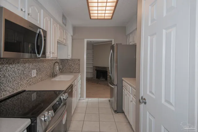 a kitchen with a sink stove and cabinets
