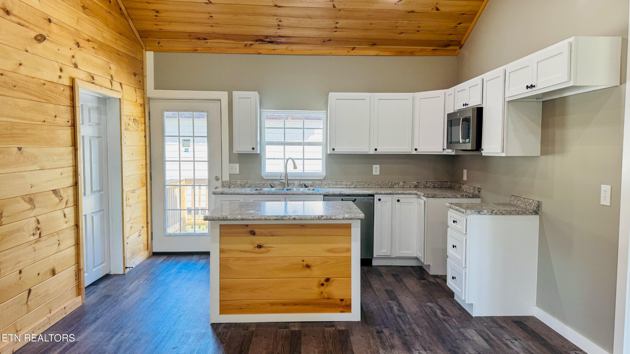 138 Lloyd Street Oneida, TN 37841 - Photo 16 of 36 a kitchen with a refrigerator a stove top oven and wooden floor