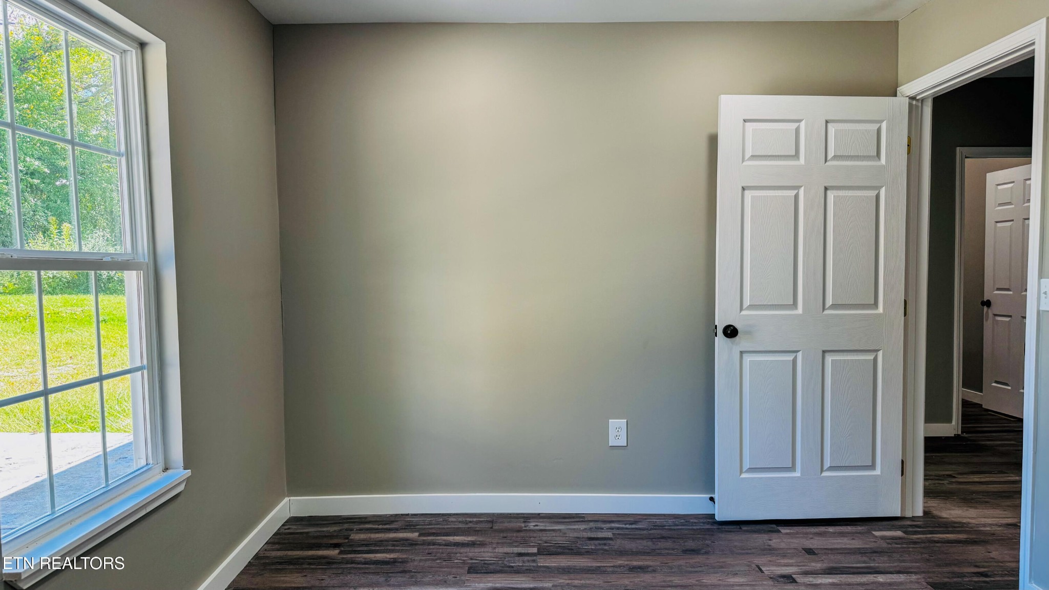 138 Lloyd Street Oneida, TN 37841 - Photo 30 of 36 an empty room with wooden floor and windows
