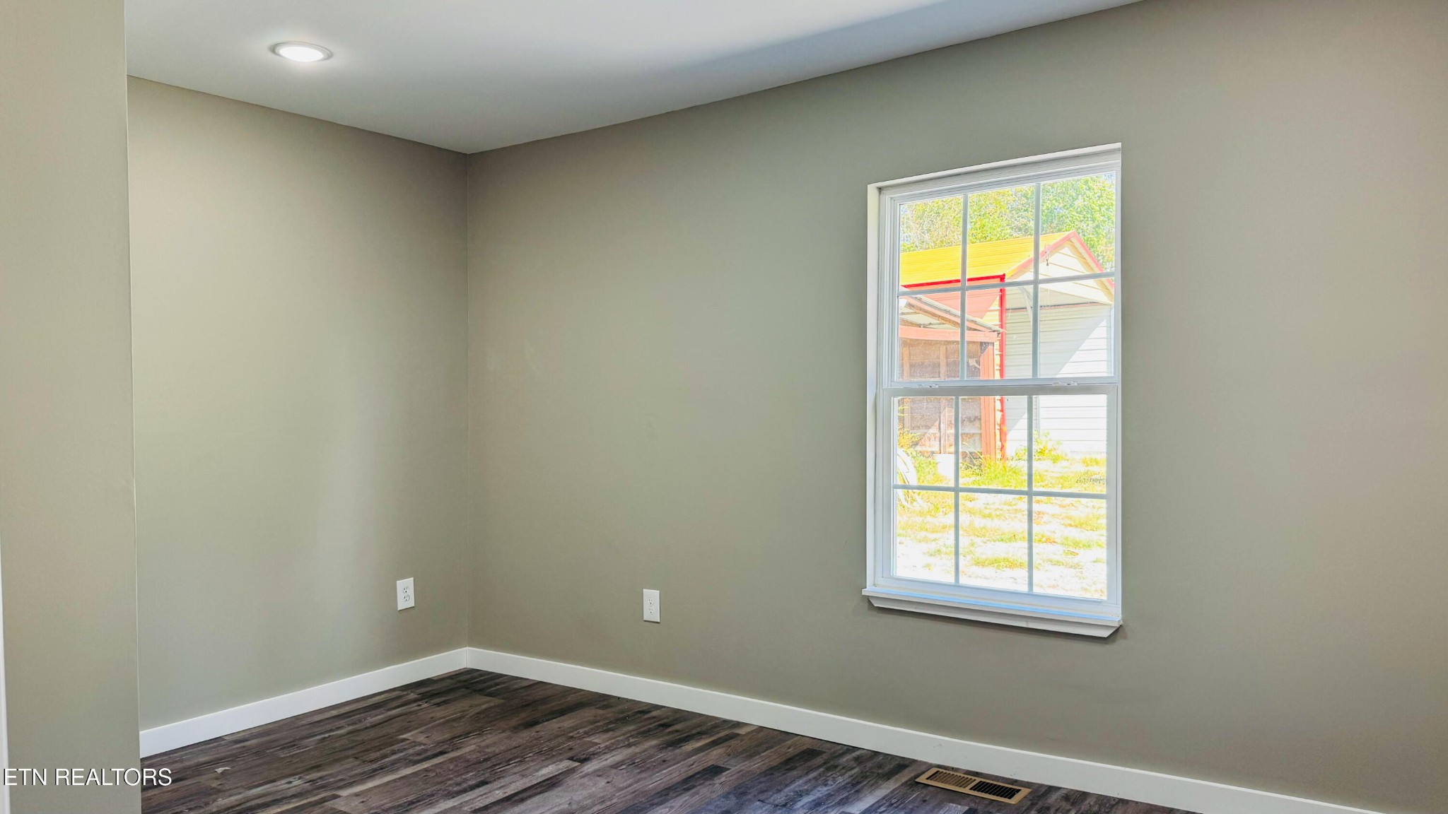 138 Lloyd Street Oneida, TN 37841 - Photo 31 of 36 an empty room with a window and wooden floor