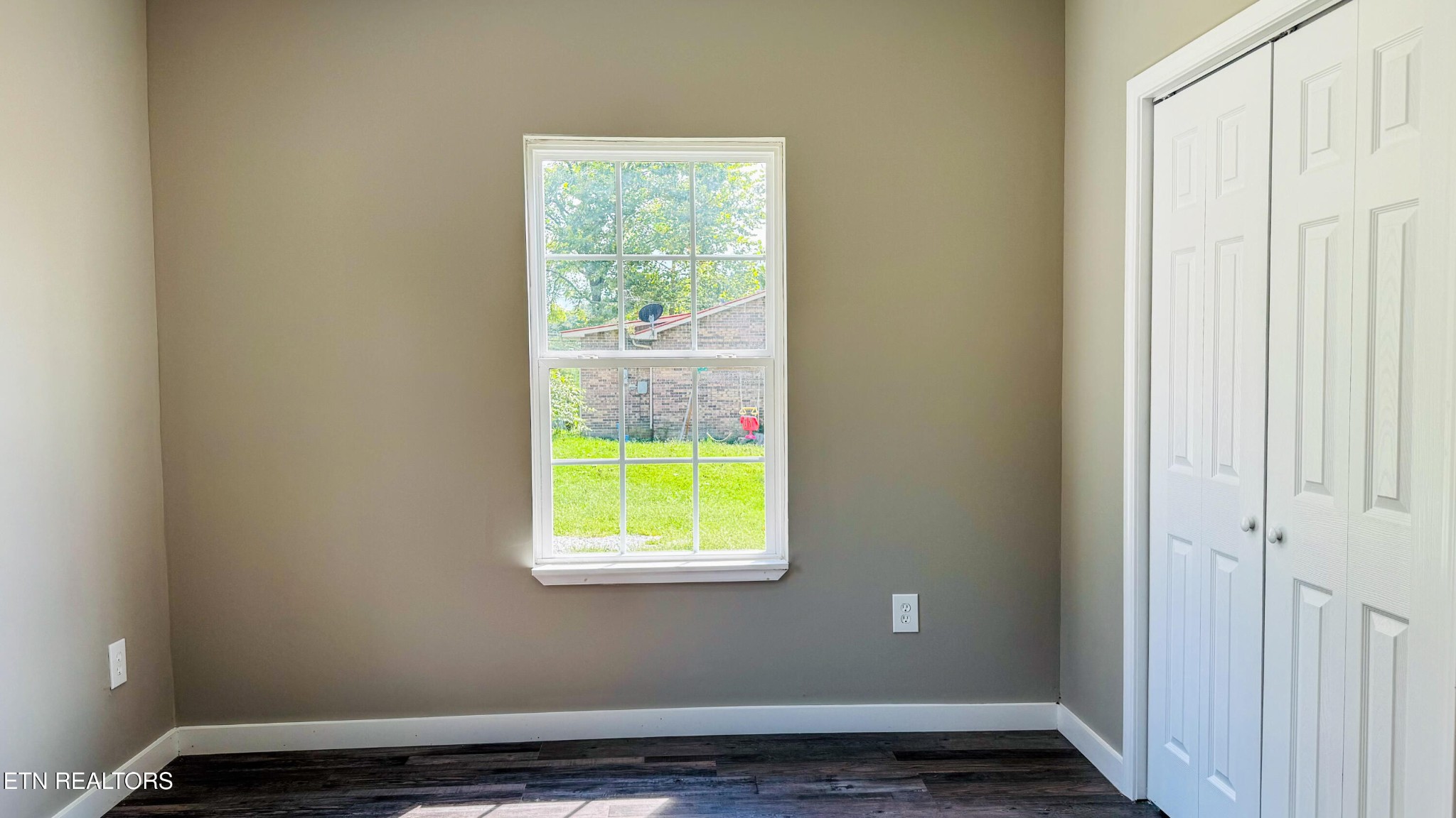 138 Lloyd Street Oneida, TN 37841 - Photo 32 of 36 a view of an empty room with wooden floor and a window