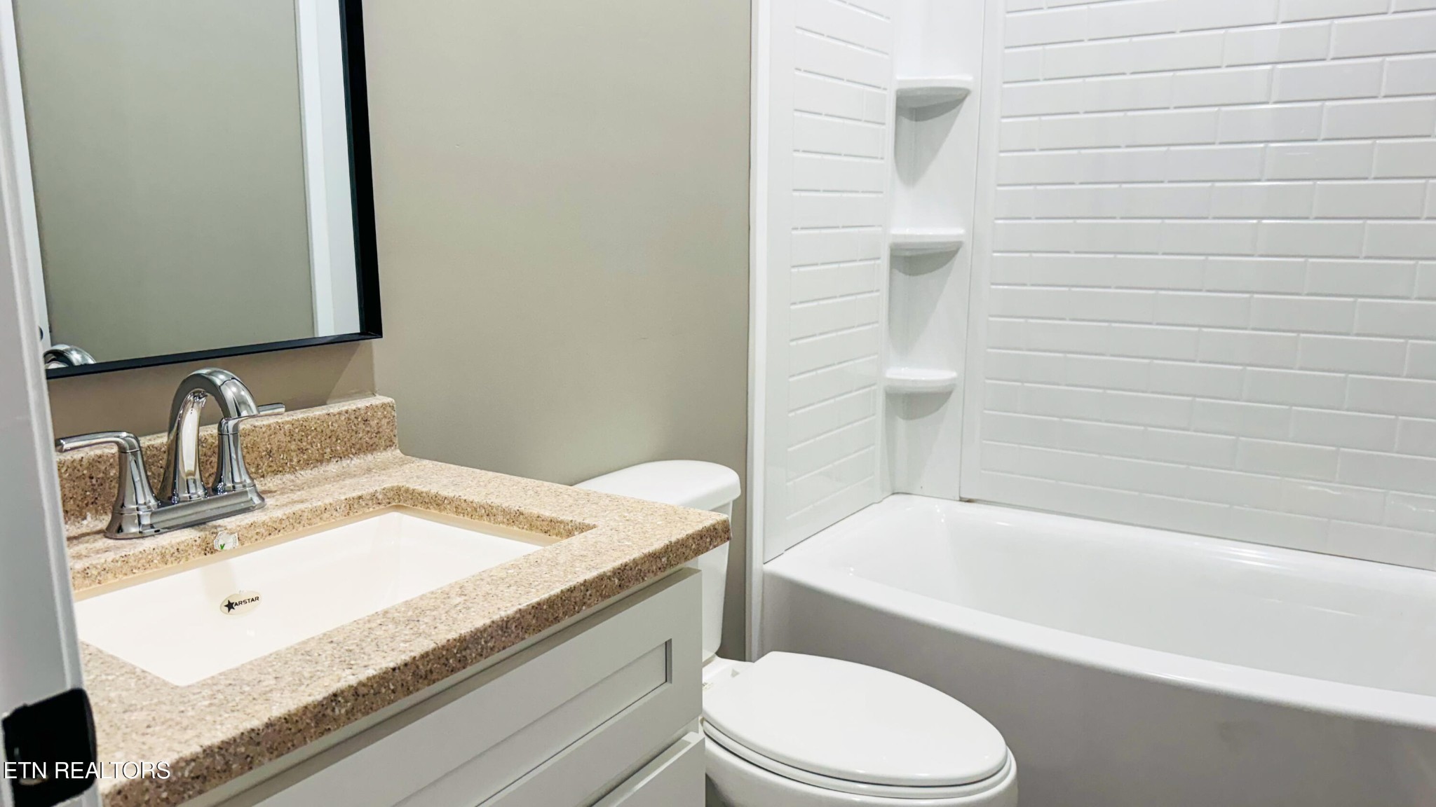 138 Lloyd Street Oneida, TN 37841 - Photo 34 of 36 a bathroom with a granite countertop bathtub sink vanity mirror and toilet