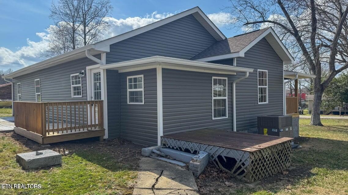 138 Lloyd Street Oneida, TN 37841 - Photo 6 of 36 a view of a house with a small deck and a fire pit
