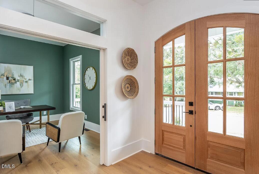 712 Van Buren Road Raleigh, NC 27604 - Photo 3 of 34 a view of a hallway with entryway wooden floor and door