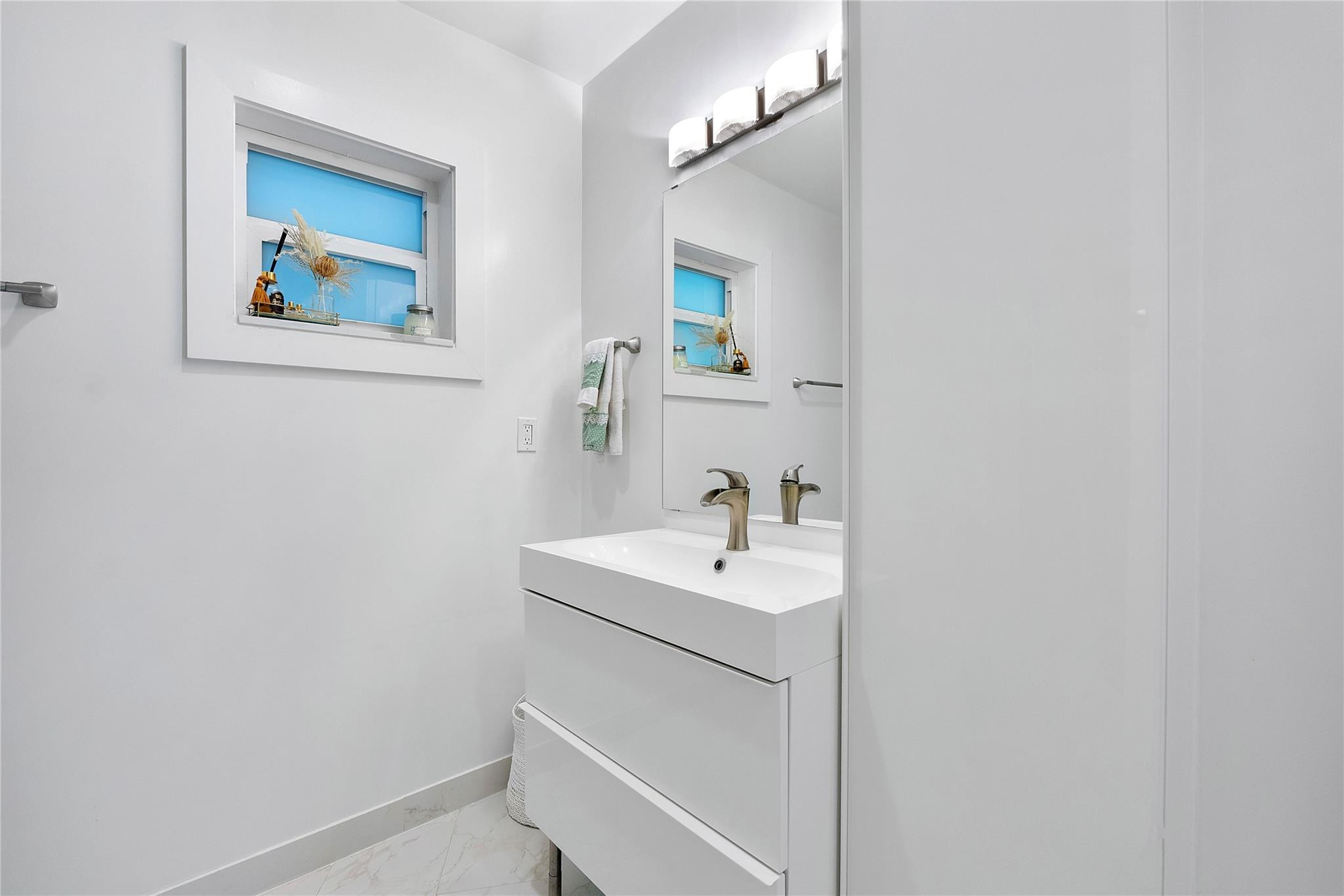 5351 Godfrey Road Parkland, FL 33067 - Photo 32 of 95 a bathroom with a sink and a mirror