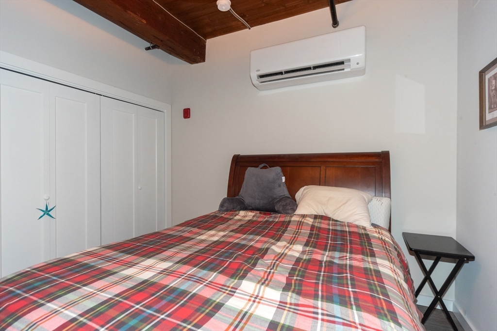 55 Sterling Street, Unit 305 Clinton, MA 01510 - Photo 12 of 31 a bedroom with a bed and wooden floor