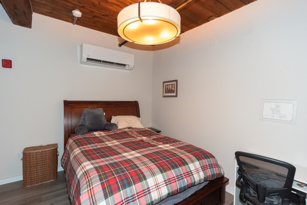 55 Sterling Street, Unit 305 Clinton, MA 01510 - Photo 13 of 31 a bedroom with a bed and a lamp next to a window