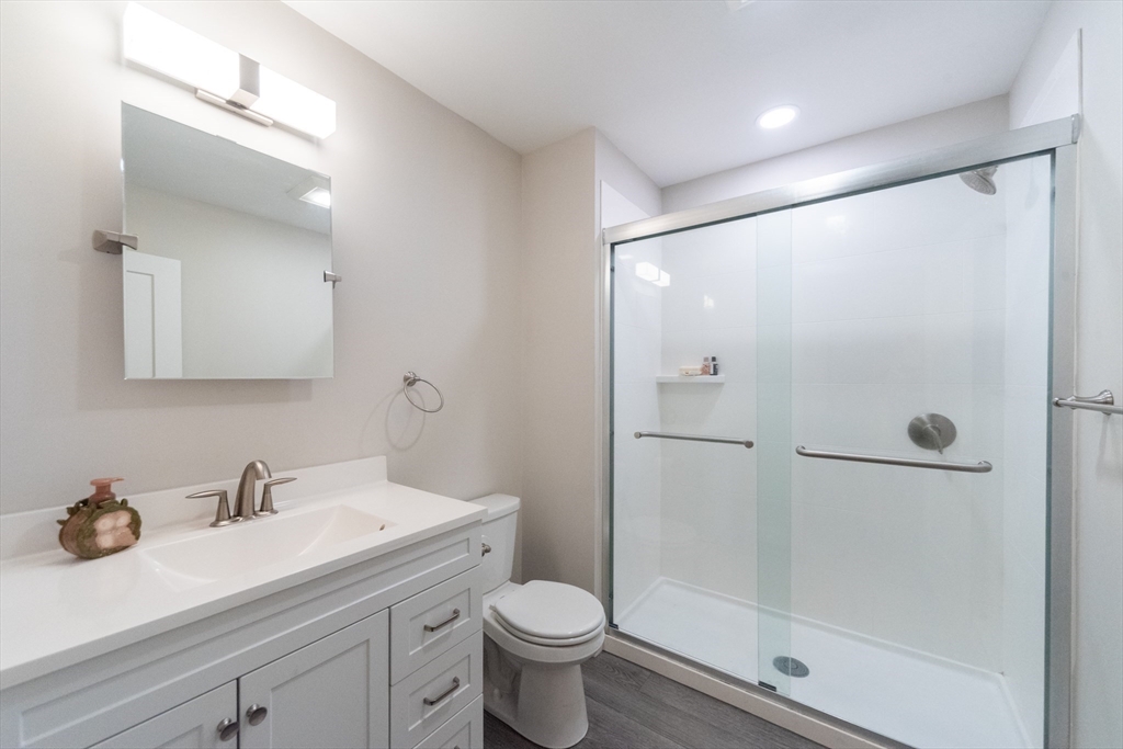 55 Sterling Street, Unit 305 Clinton, MA 01510 - Photo 10 of 31 a bathroom with a granite countertop sink toilet and shower