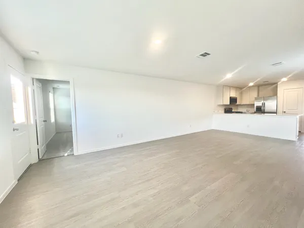a view of a kitchen with a sink and a refrigerator