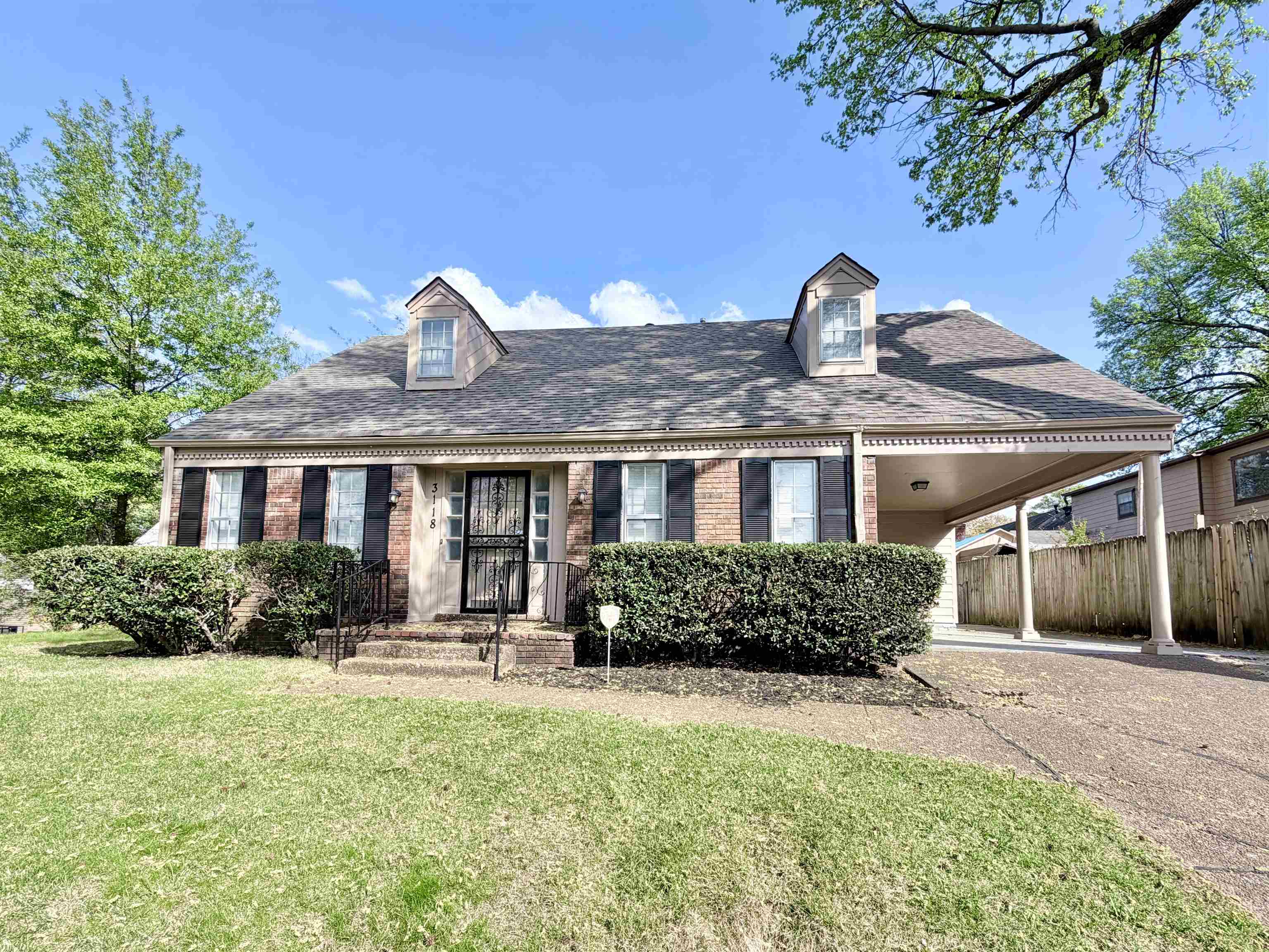 a front view of a house with garden