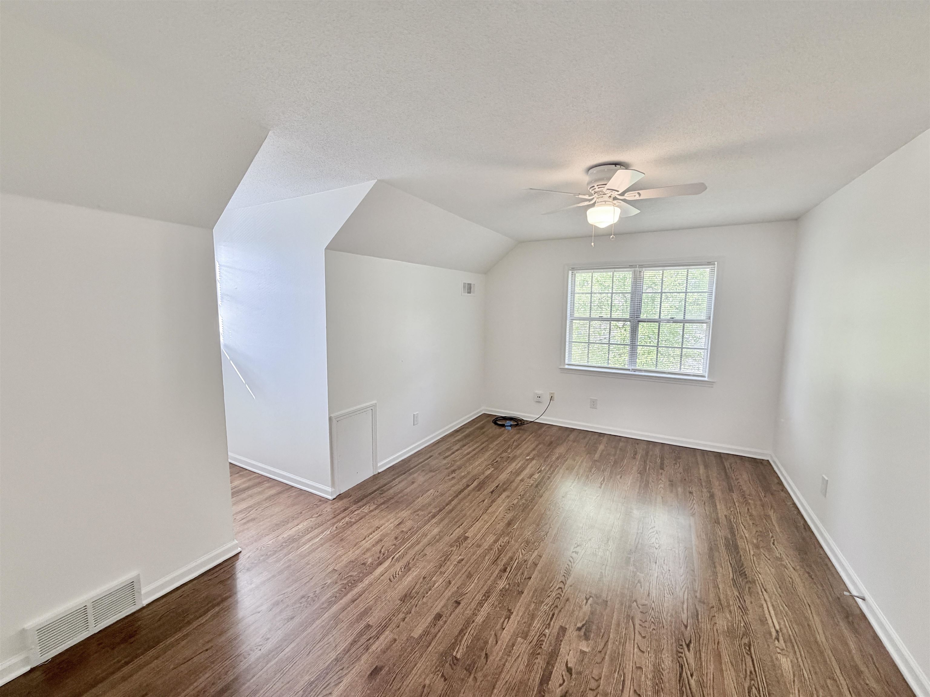 3118 Estes Street Memphis, TN 38115 - Photo 15 of 32 an empty room with wooden floor and windows