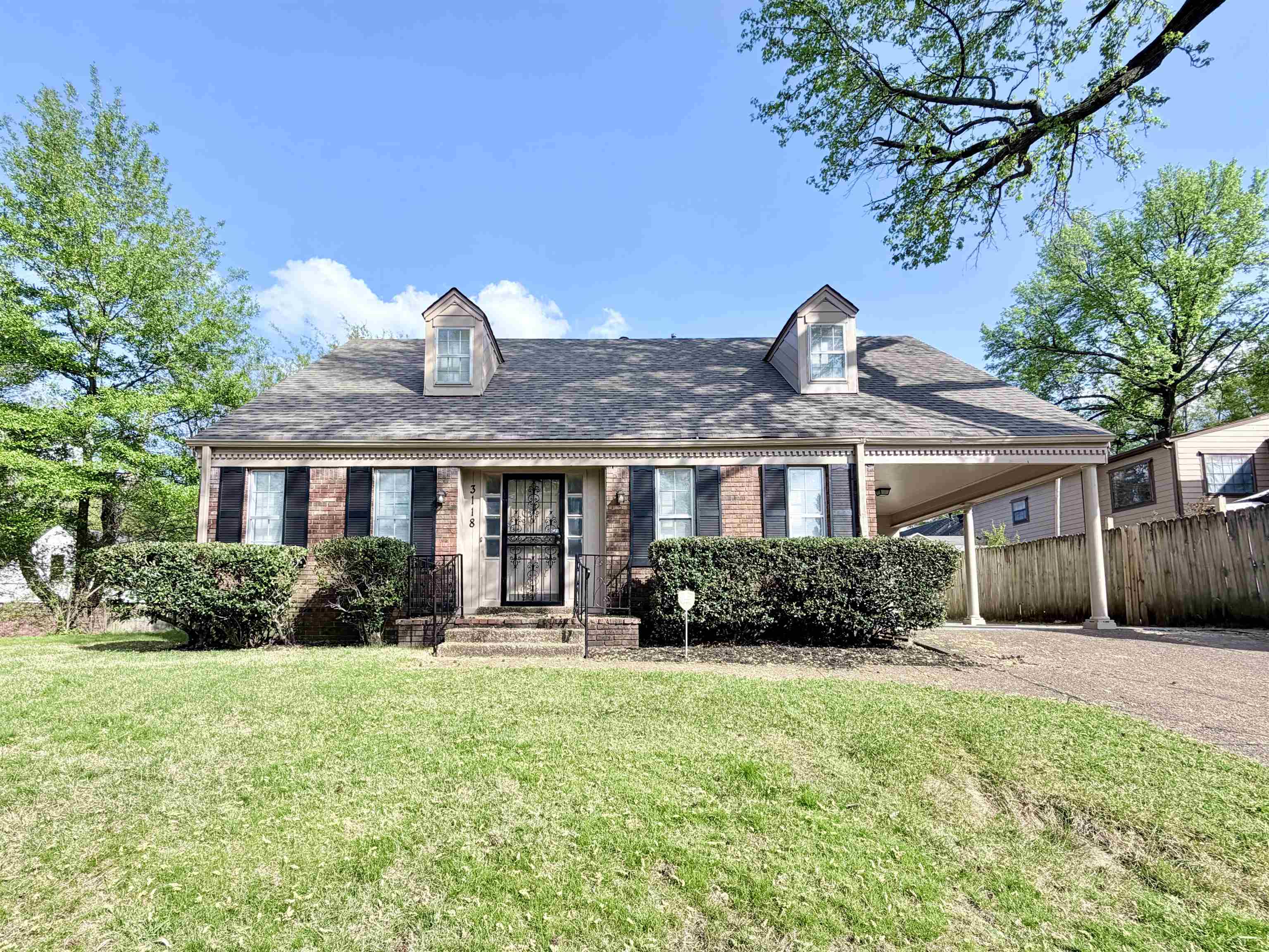 3118 Estes Street Memphis, TN 38115 - Photo 25 of 32 a front view of a house with garden
