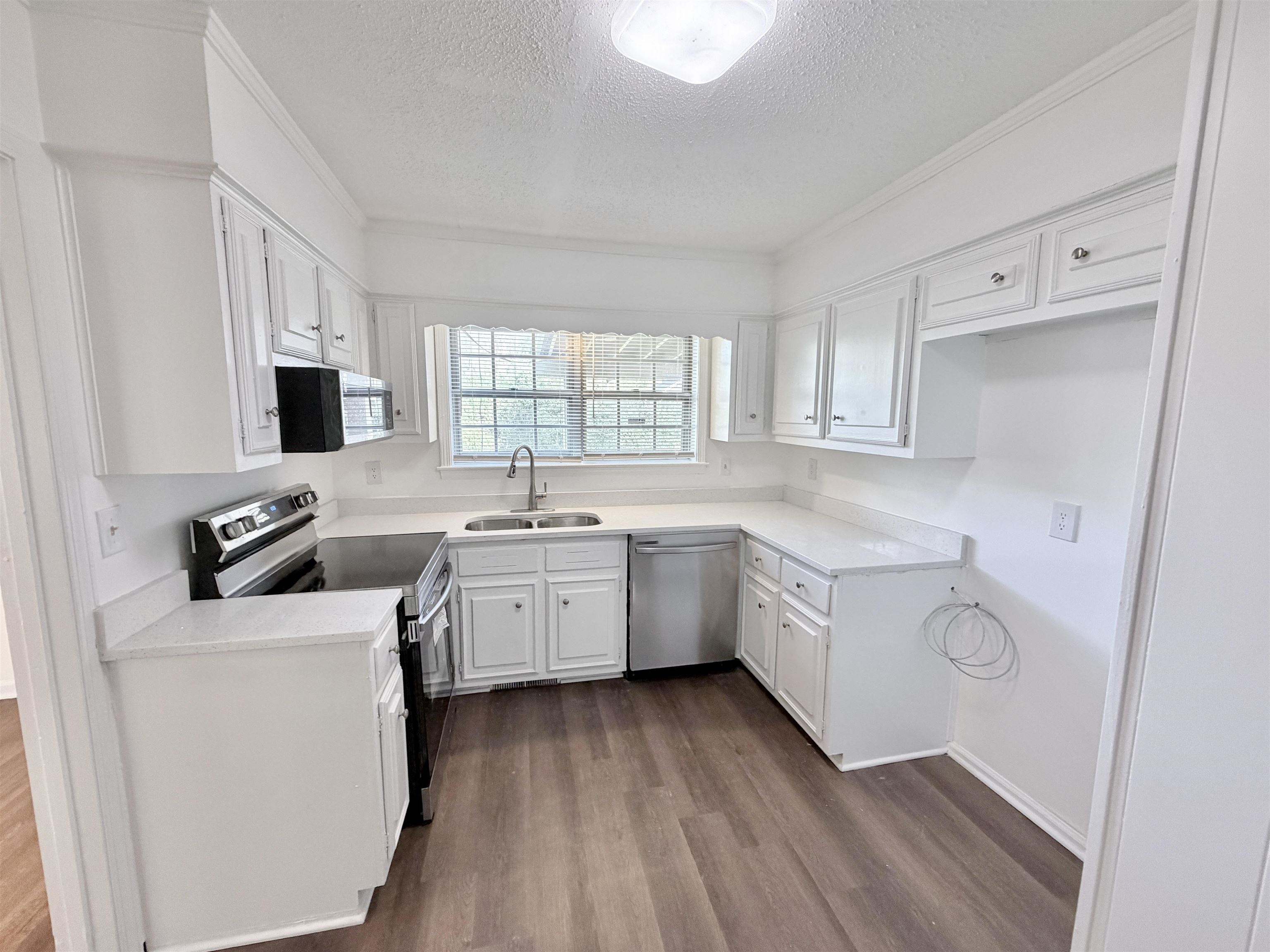 3118 Estes Street Memphis, TN 38115 - Photo 3 of 32 a kitchen with a stove a sink and a microwave