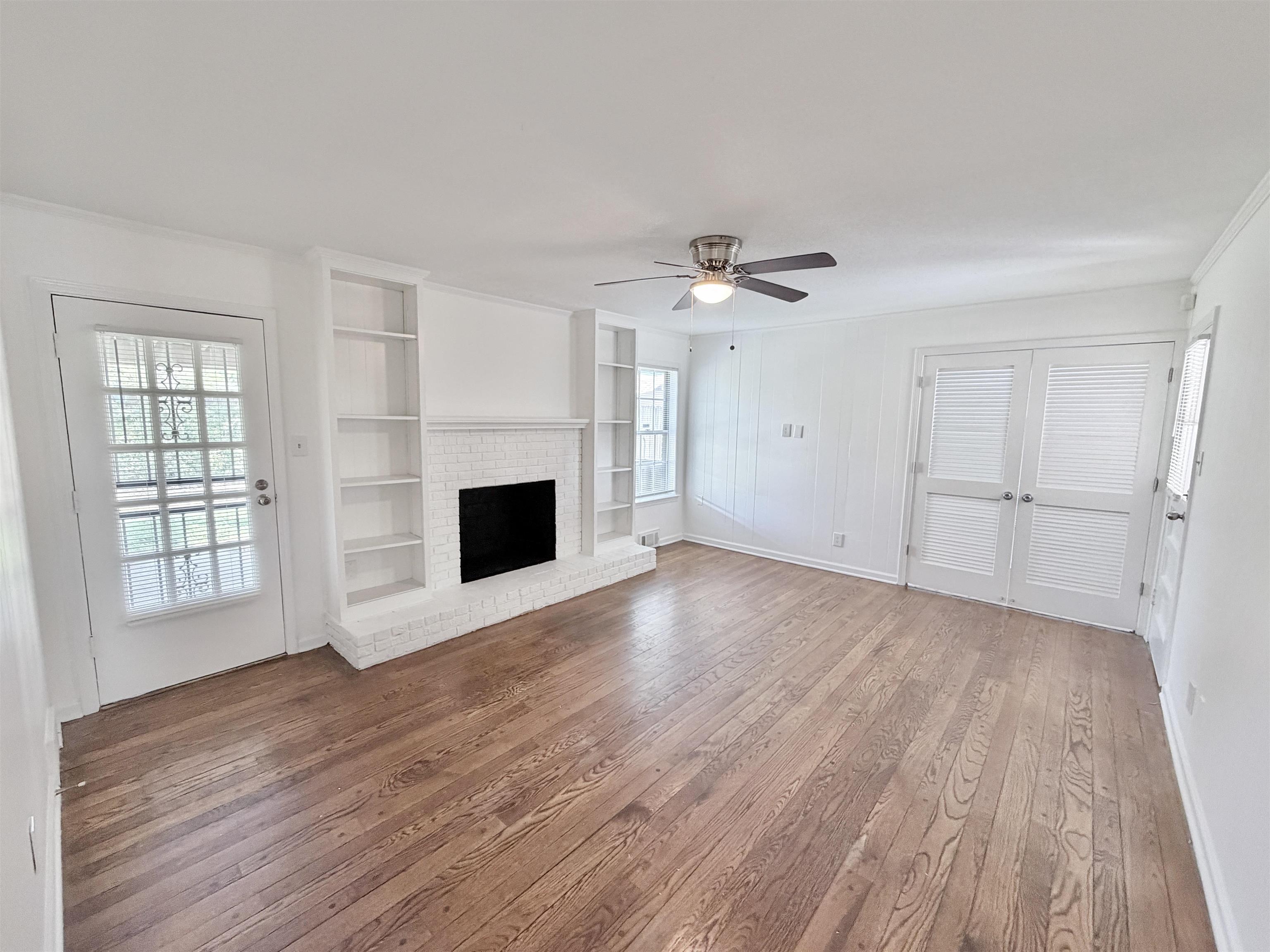 3118 Estes Street Memphis, TN 38115 - Photo 6 of 32 an empty room with windows and fireplace