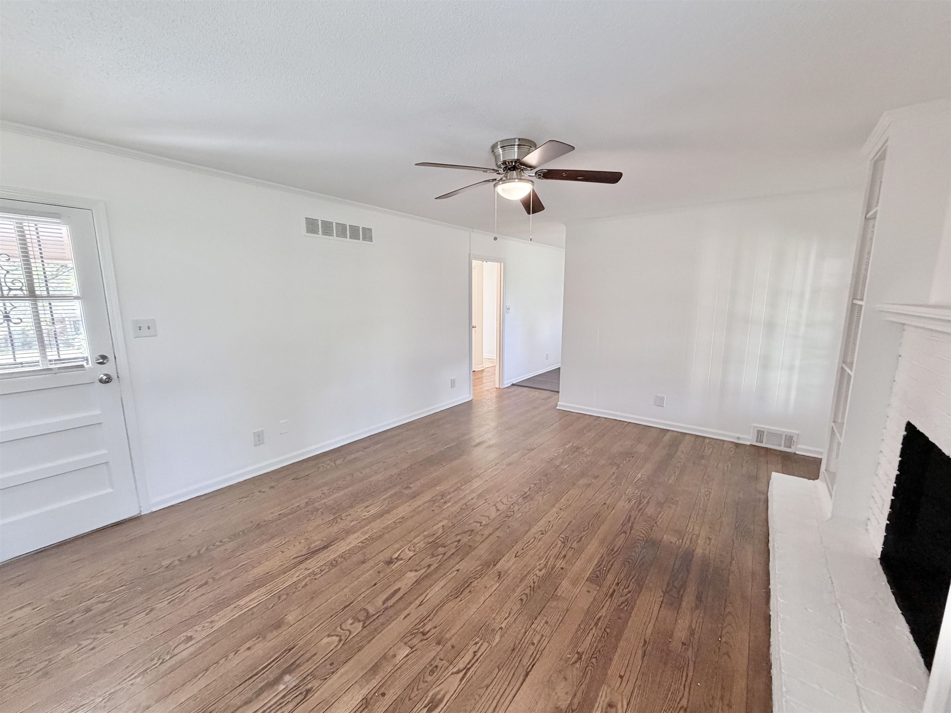 3118 Estes Street Memphis, TN 38115 - Photo 7 of 32 wooden floor in an empty room with a window