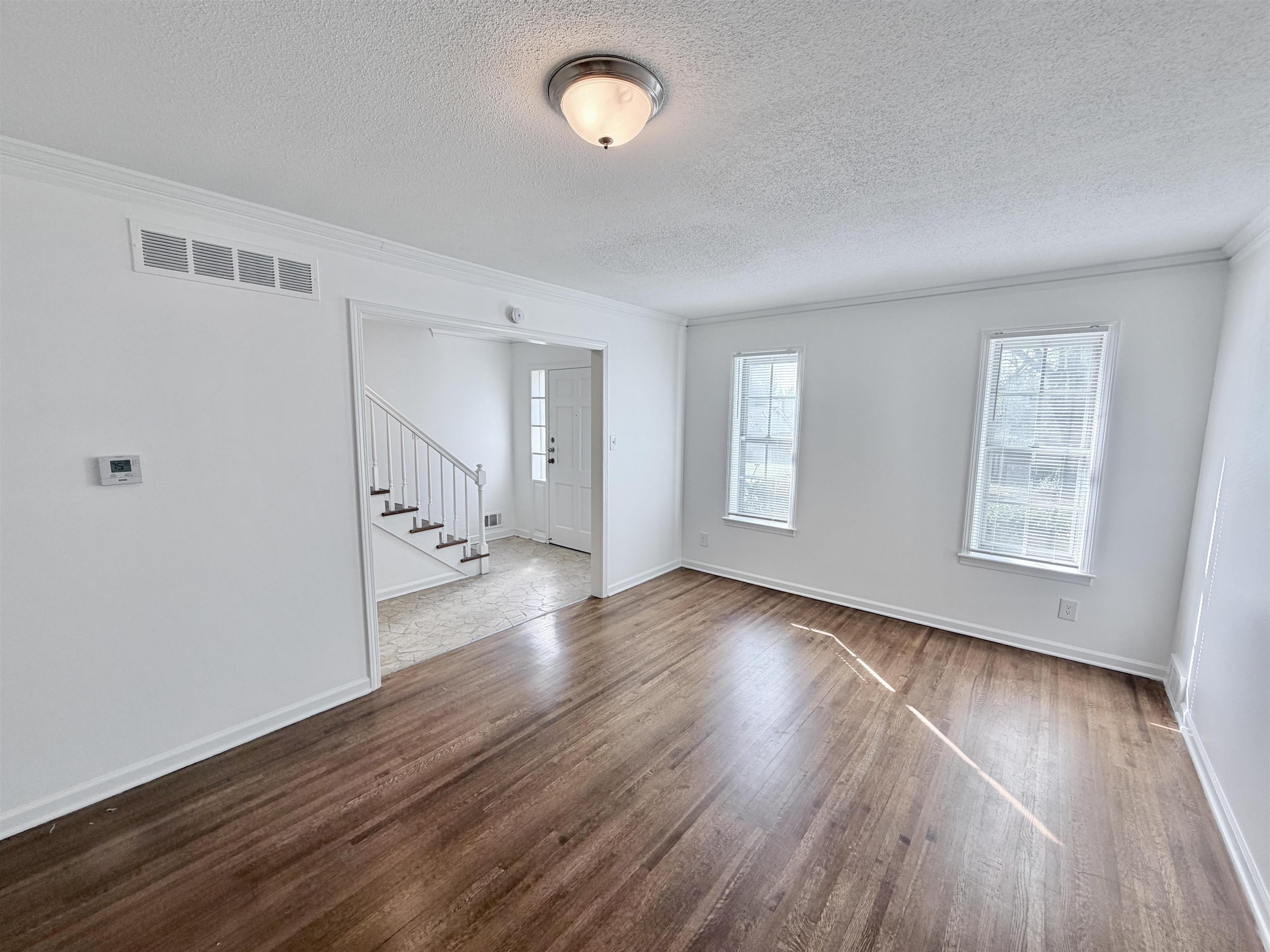 3118 Estes Street Memphis, TN 38115 - Photo 8 of 32 an empty room with wooden floor and windows