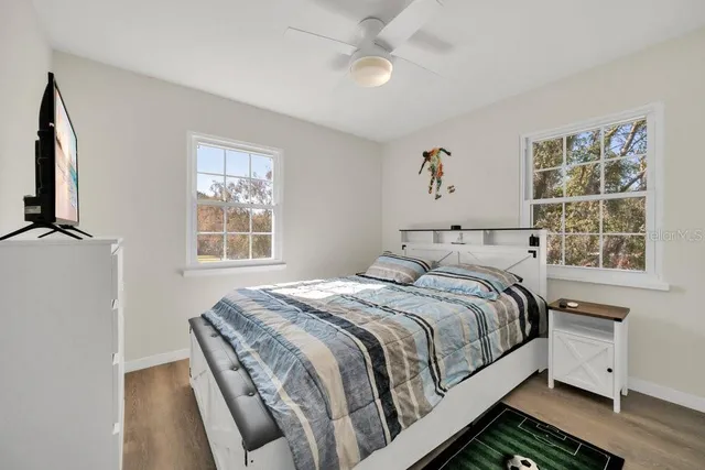 a bedroom with a bed and a window