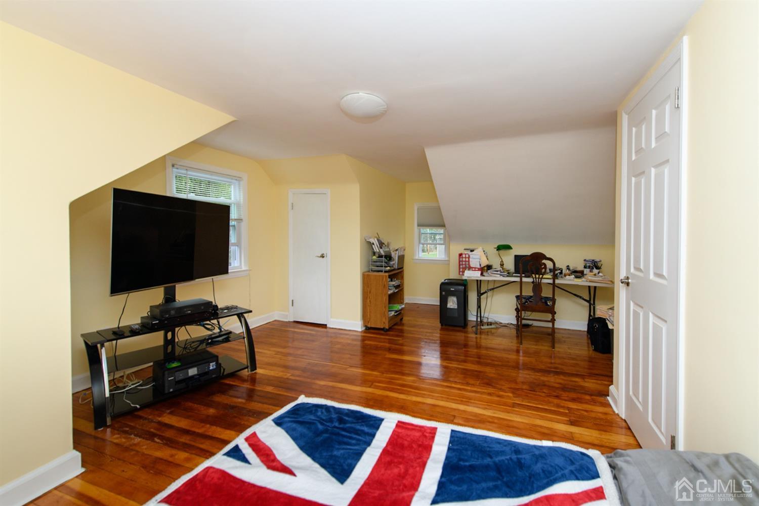 62 Middlesex Road Matawan, NJ 07747 - Photo 14 of 38 a living room with furniture and a flat screen tv