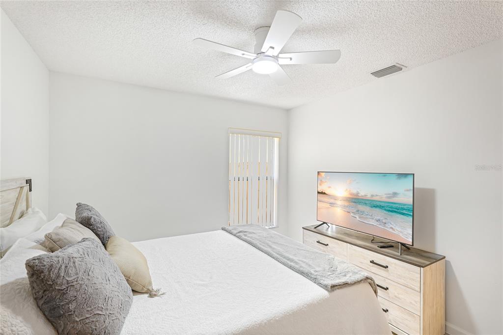 4537 South Lockwood Ridge Road Sarasota, FL 34231 - Photo 15 of 22 a bedroom with a bed and a flat screen tv