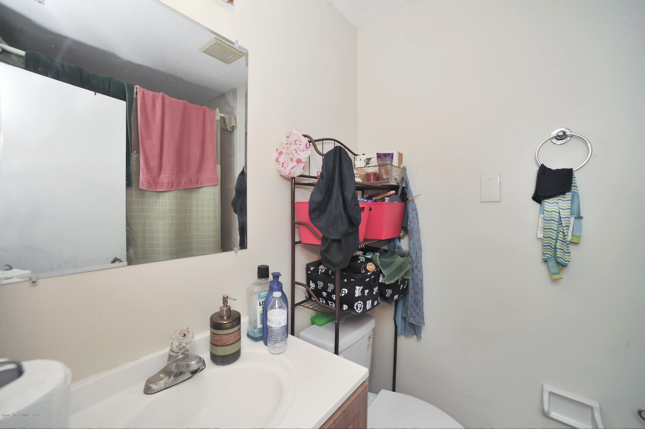 461 Wildmer Road Southwest Palm Bay, FL 32908 - Photo 12 of 15 a bathroom with a sink vanity mirror and toilet