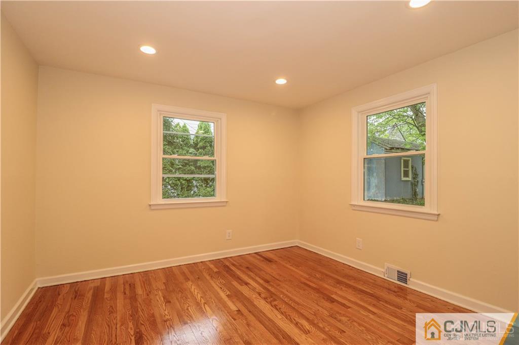 20 Old Post Road Edison, NJ 08817 - Photo 16 of 25 a view of an empty room with wooden floor and a window