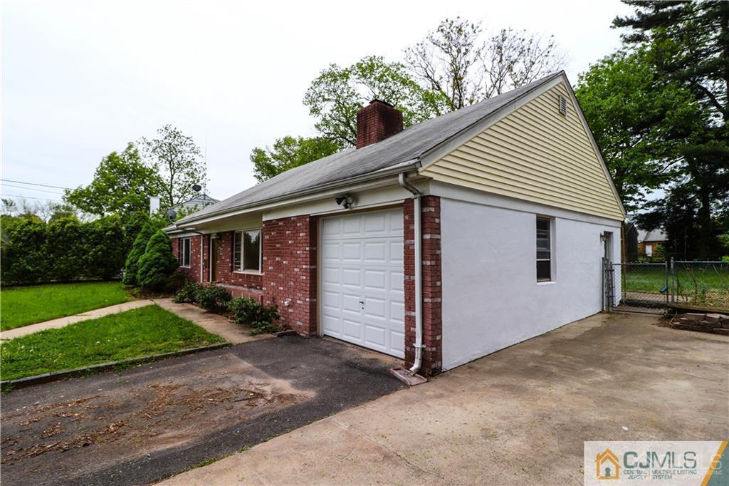 20 Old Post Road Edison, NJ 08817 - Photo 23 of 25 a front view of a house with a yard and garage
