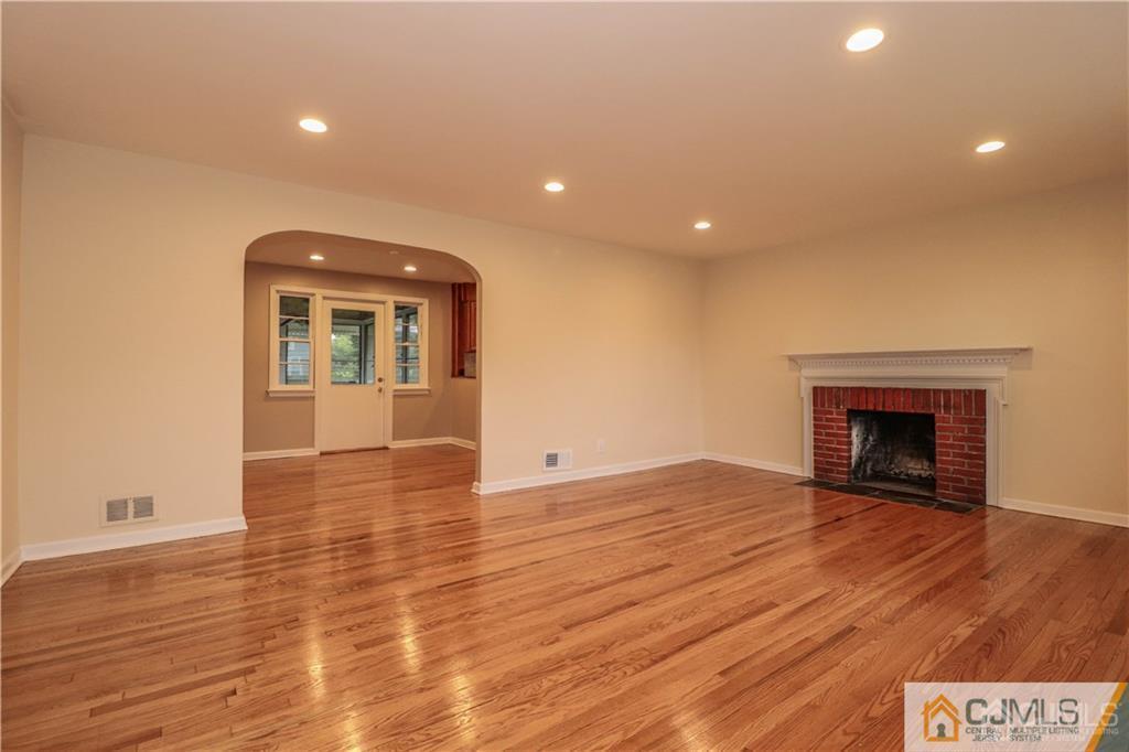 20 Old Post Road Edison, NJ 08817 - Photo 4 of 25 a view of an empty room with wooden floor and a fireplace