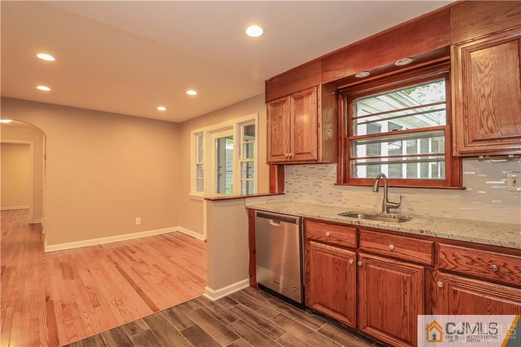 20 Old Post Road Edison, NJ 08817 - Photo 7 of 25 a kitchen with kitchen island granite countertop wooden cabinets and a sink
