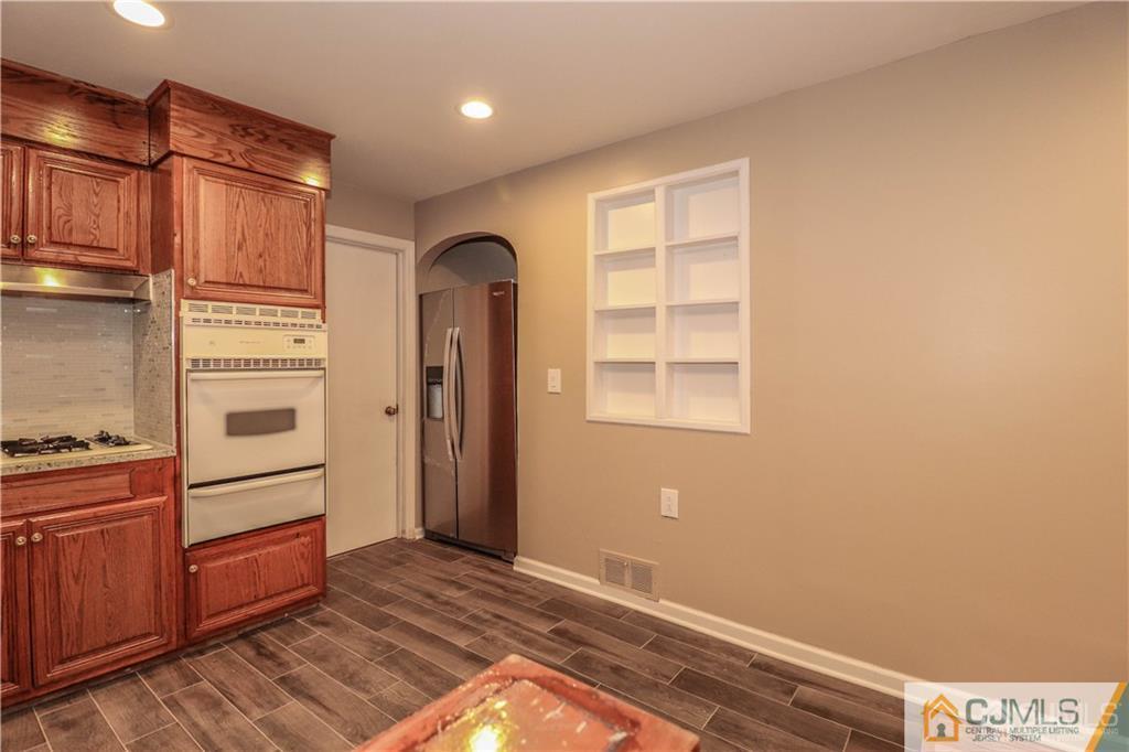 20 Old Post Road Edison, NJ 08817 - Photo 8 of 25 a view of a kitchen with wooden cabinet and an empty room